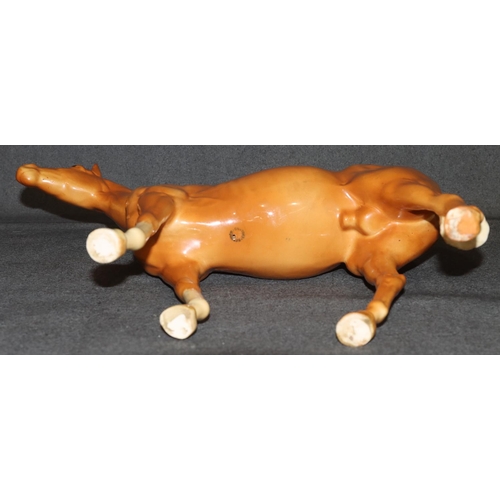 4 - A large Beswick figure of a Palomino horse, 28.5cm high, 36cm long