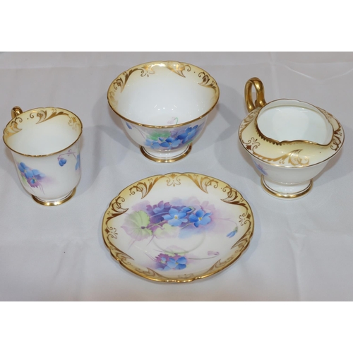 53 - A Shelley tea service on white and cream ground with multi-coloured floral, leaf and gilt decoration... 