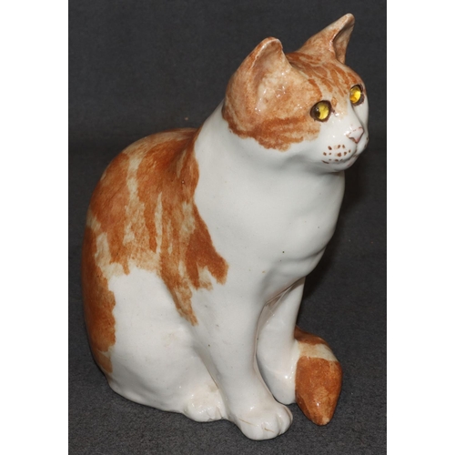 63 - A Winstanley model of a seated ginger cat with glass eyes, 29.5cm high