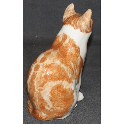 63 - A Winstanley model of a seated ginger cat with glass eyes, 29.5cm high