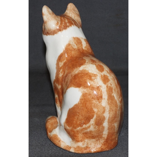 63 - A Winstanley model of a seated ginger cat with glass eyes, 29.5cm high