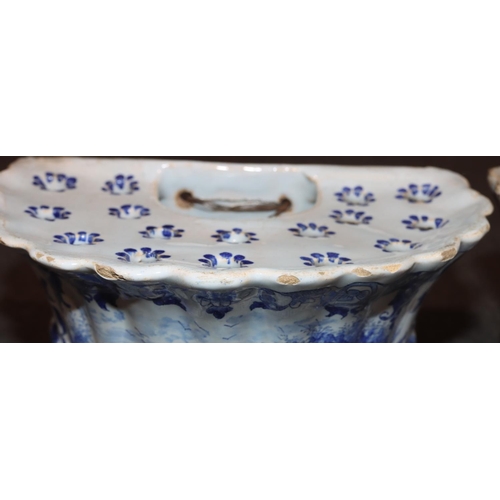 67 - A pair of Dutch blue and white bough pots with figure, floral and landscape decoration, 17cm wide