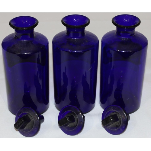 73 - A set of 3 Bristol blue glass chemist's round cylindrical jars with thin necks and stoppers, 20.5cm ... 