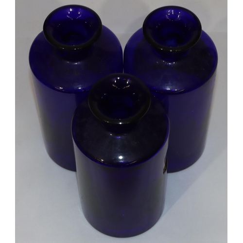 73 - A set of 3 Bristol blue glass chemist's round cylindrical jars with thin necks and stoppers, 20.5cm ... 