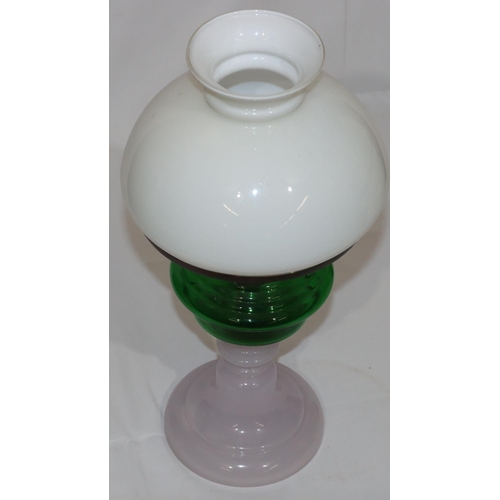 77 - An Opaline and green glass paraffin lamp, with shade (no chimney), 44cm high