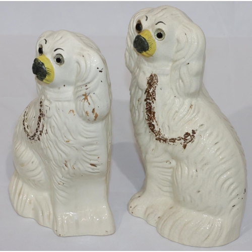 79 - A pair of 19th Century Staffordshire figures of seated spaniels with painted gilt decoration and gla... 