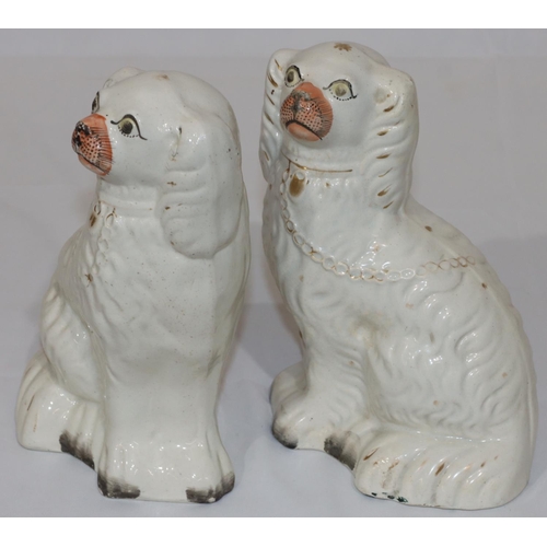 80 - A pair of 19th Century Staffordshire figures of seated spaniels with gilt chain decoration and paint... 