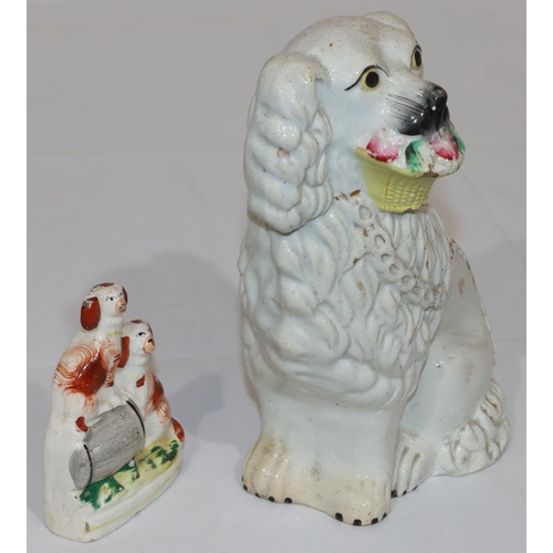 83 - A 19th Century Staffordshire figure of a seated spaniel holding basket in its mouth with gilt decora... 