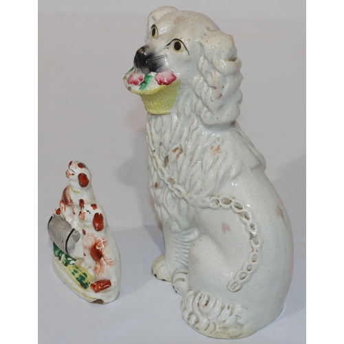 83 - A 19th Century Staffordshire figure of a seated spaniel holding basket in its mouth with gilt decora... 