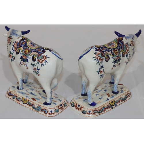 87 - A pair of Continental Delft figures of cattle on white ground with multi-coloured floral, leaf and s... 