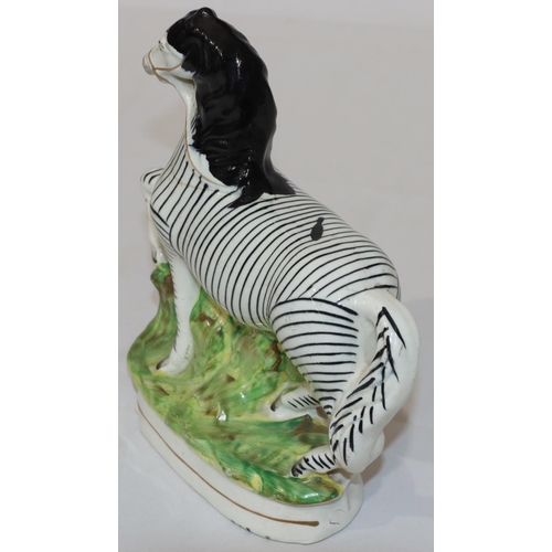 90 - A 19th Century Staffordshire figure of a Zebra, 22.5cm high (crack around neck and top front right l... 