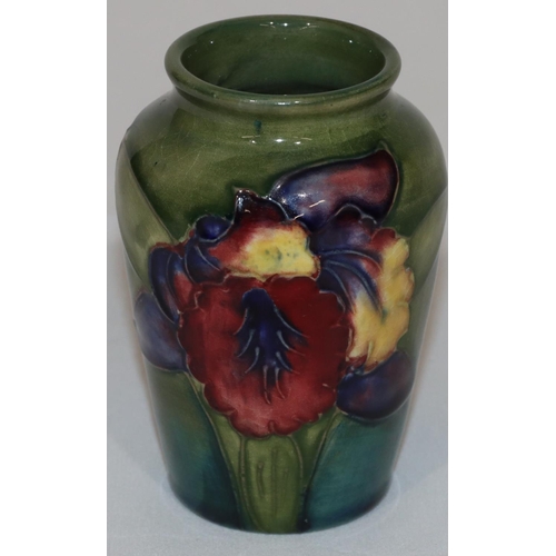 99 - A Moorcroft small round thin necked vase on green ground with multi-coloured floral and leaf decorat... 