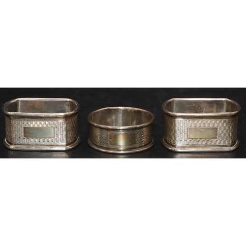 234 - A pair of Sheffield silver rectangular shaped napkin rings with engine turned decoration and a Birmi... 