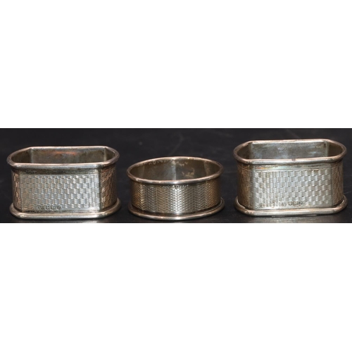 234 - A pair of Sheffield silver rectangular shaped napkin rings with engine turned decoration and a Birmi... 