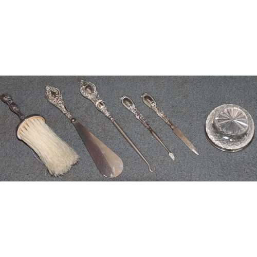 241 - A silver handled brush with embossed decoration and cupid motifs, 4 manicure items and a cut glass r... 