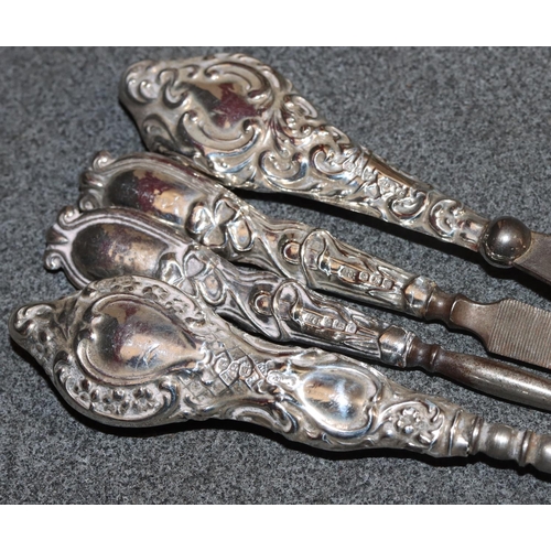 241 - A silver handled brush with embossed decoration and cupid motifs, 4 manicure items and a cut glass r... 