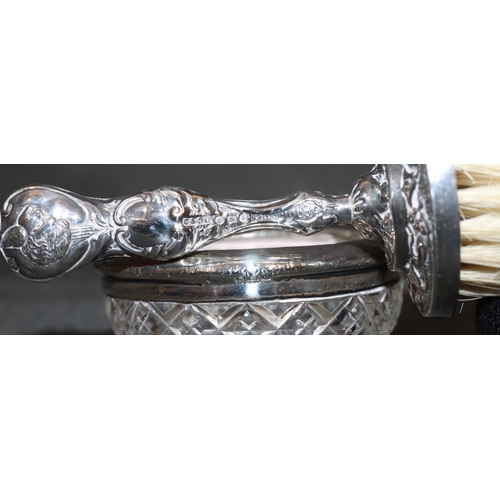 241 - A silver handled brush with embossed decoration and cupid motifs, 4 manicure items and a cut glass r... 