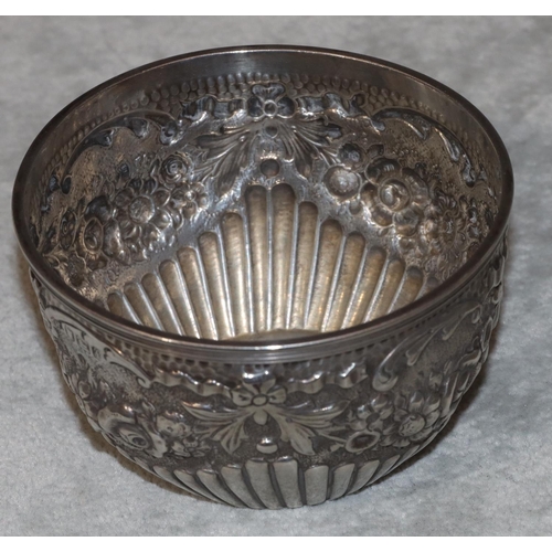 249 - An Edward VII silver round sugar bowl with allover embossed fluted swag, floral and leaf decoration,... 