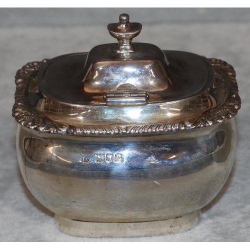 251 - A George V silver rectangular bulbous shaped tea caddy with hinged lid and raised shell and scroll r... 