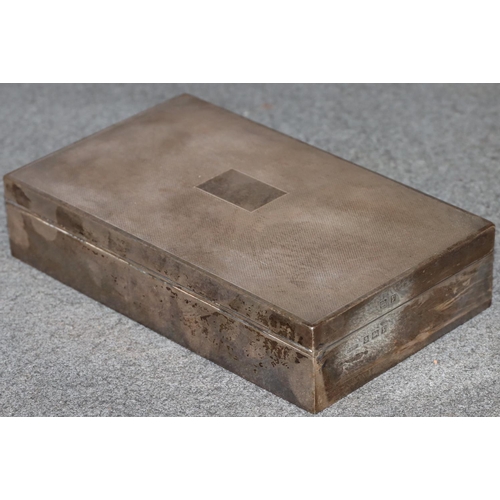 265 - A Birmingham silver rectangular shaped cigarette box with engine turned hinged lid enclosing cedar l... 