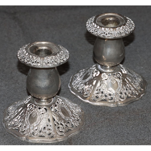 283 - A pair of Godinger silver plated dwarf candlesticks on bulbous stems with splayed pierced bases and ... 