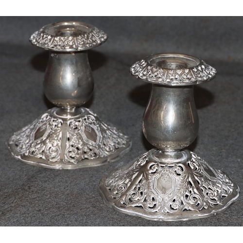 283 - A pair of Godinger silver plated dwarf candlesticks on bulbous stems with splayed pierced bases and ... 