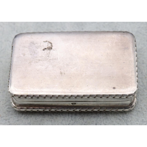 300 - A London silver small rectangular shaped snuff box with embossed figure decorated hinged lid, 5.7cm ... 