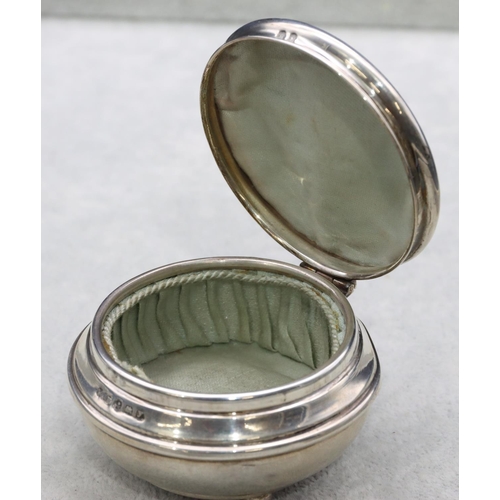 304 - A Birmingham silver round bulbous shaped trinket box with hinged lid enclosing silk interior on 3 ba... 