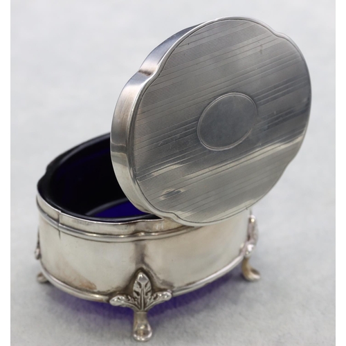 305 - A Chester silver oval scallop shaped trinket box with hinged lid enclosing odd blue glass liner on s... 