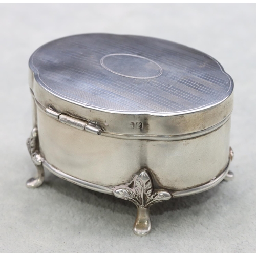 305 - A Chester silver oval scallop shaped trinket box with hinged lid enclosing odd blue glass liner on s... 