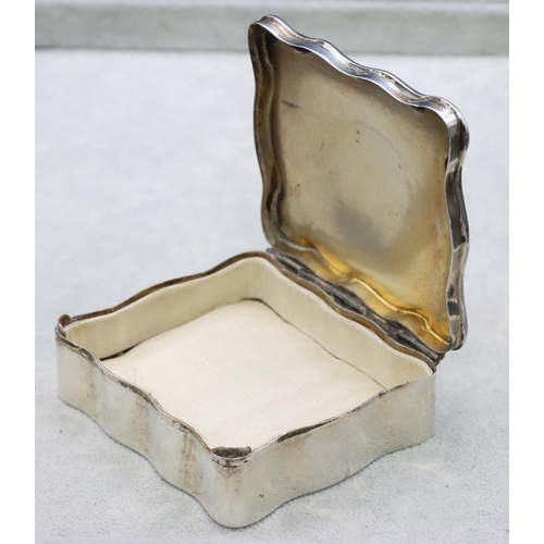 308 - A Birmingham silver rectangular scallop shaped trinket box with hinged lid enclosing cream silk inte... 