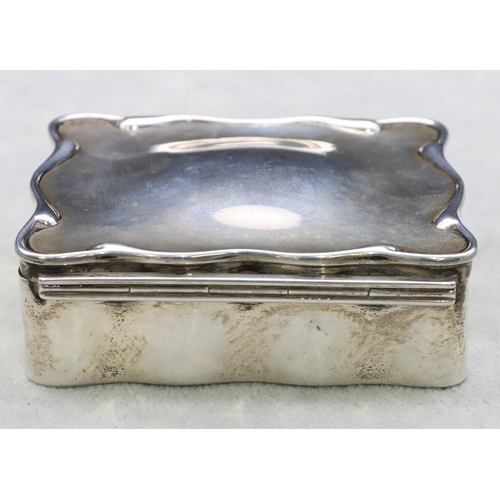 308 - A Birmingham silver rectangular scallop shaped trinket box with hinged lid enclosing cream silk inte... 