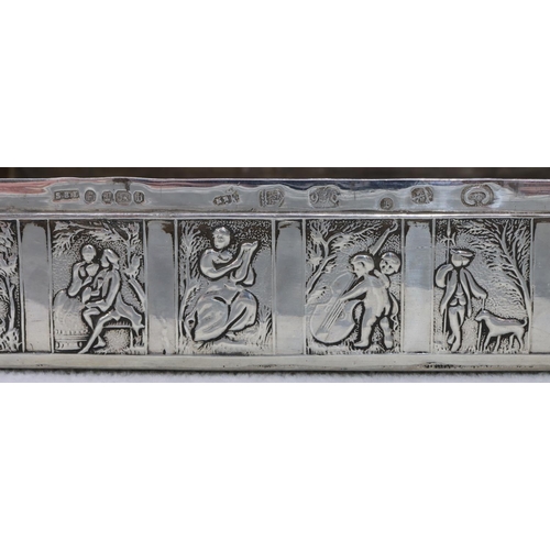 310 - A Continental silver imported rectangular shaped box with hinged lid and allover embossed figure, cu... 