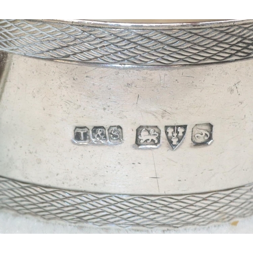 317 - 2 Birmingham silver round napkin rings with engine turned decoration and a Chester silver napkin rin... 