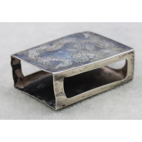 320 - A Chinese silver coloured metal matchbox holder with engraved dragon decoration, 5cm wide, 0.65oz