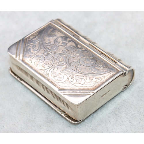 323 - A modern 925 silver novelty vesta/stamp case in the form of a book with double hinged sides and engr... 