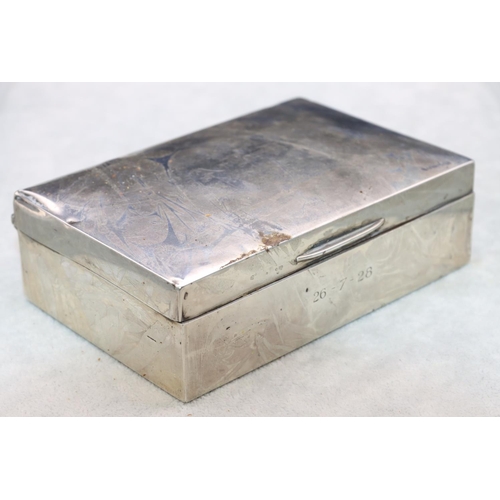 324 - A George V silver rectangular shaped cigarette box with arched hinged lid enclosing cedar lined inte... 