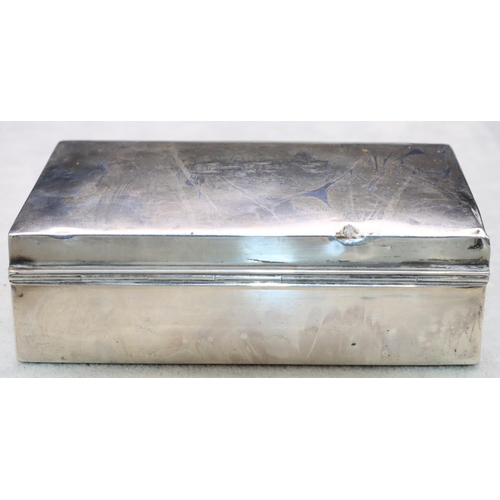 324 - A George V silver rectangular shaped cigarette box with arched hinged lid enclosing cedar lined inte... 