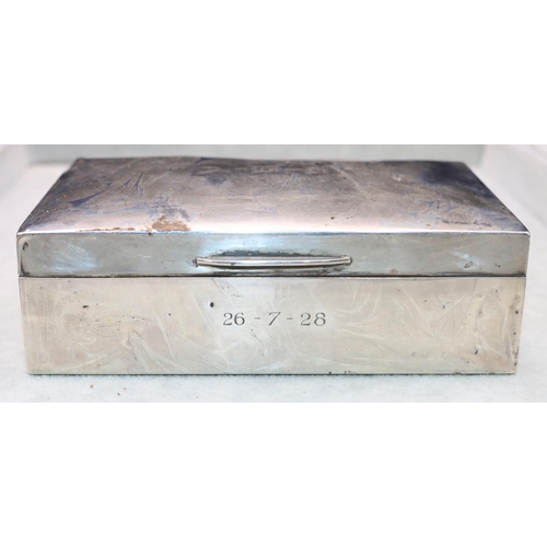 324 - A George V silver rectangular shaped cigarette box with arched hinged lid enclosing cedar lined inte... 