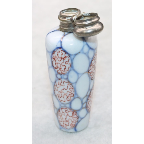 326 - A china round scent bottle with silver hinged lid on white, red and blue ground, 8.2cm high