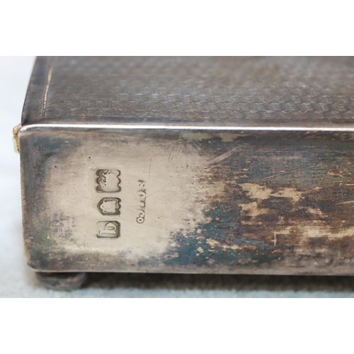 332 - A George V silver rectangular shaped large 4-box matchbox holder with engine turned decoration on bu... 