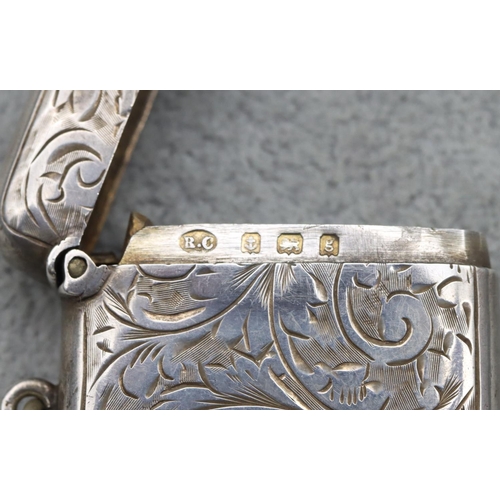 342 - An Edward VII silver vesta case with chased scroll and leaf decoration and hinged lid, Birmingham 19... 