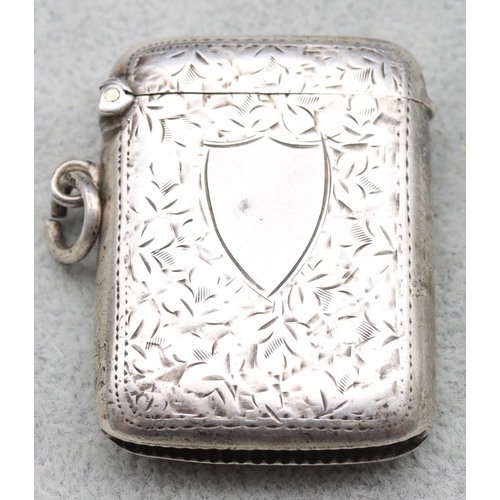 355 - A Birmingham silver vesta case with chased leaf decoration and hinged lid, 0.82oz