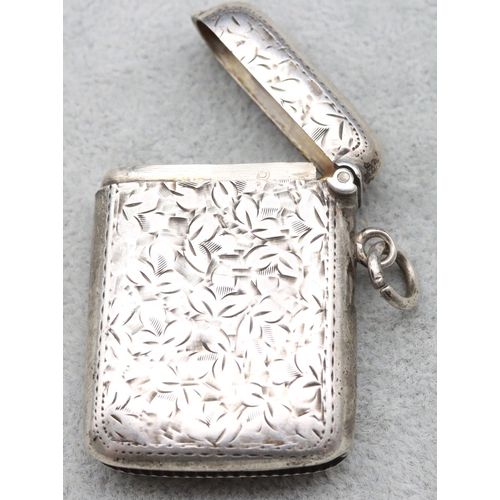 355 - A Birmingham silver vesta case with chased leaf decoration and hinged lid, 0.82oz