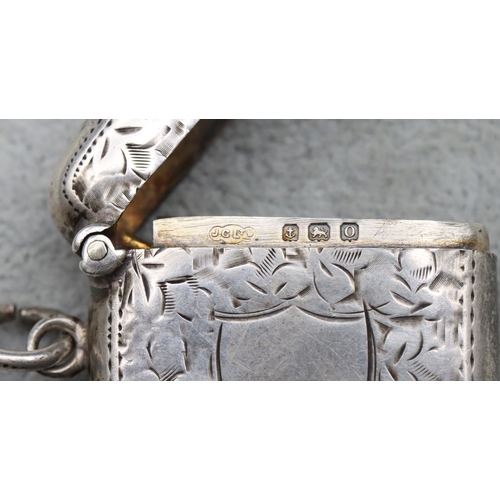 355 - A Birmingham silver vesta case with chased leaf decoration and hinged lid, 0.82oz