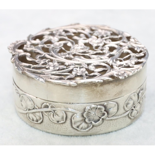 356 - An Art Nouveau silver circular Pot Pourri pot with pierced cover and allover embossed floral and lea... 