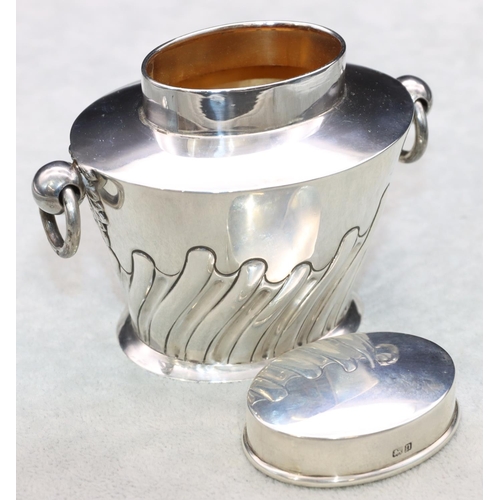 363 - An oval George V silver 2-handled lidded tea caddy with part embossed reeded decoration, Birmingham ... 