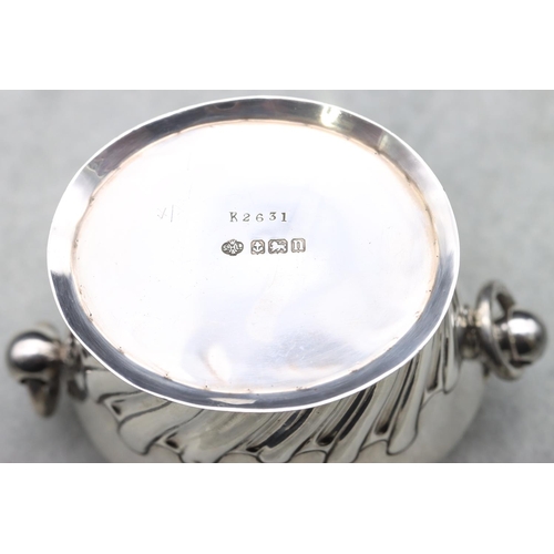 363 - An oval George V silver 2-handled lidded tea caddy with part embossed reeded decoration, Birmingham ... 