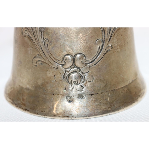 368 - An 830 silver coloured metal round bulbous shaped hand bell with embossed floral and scroll decorati... 