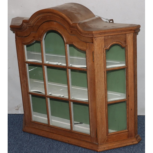 728 - A walnut hanging cabinet with arched top, astragal glazed door flanked by glass sides enclosing shap... 